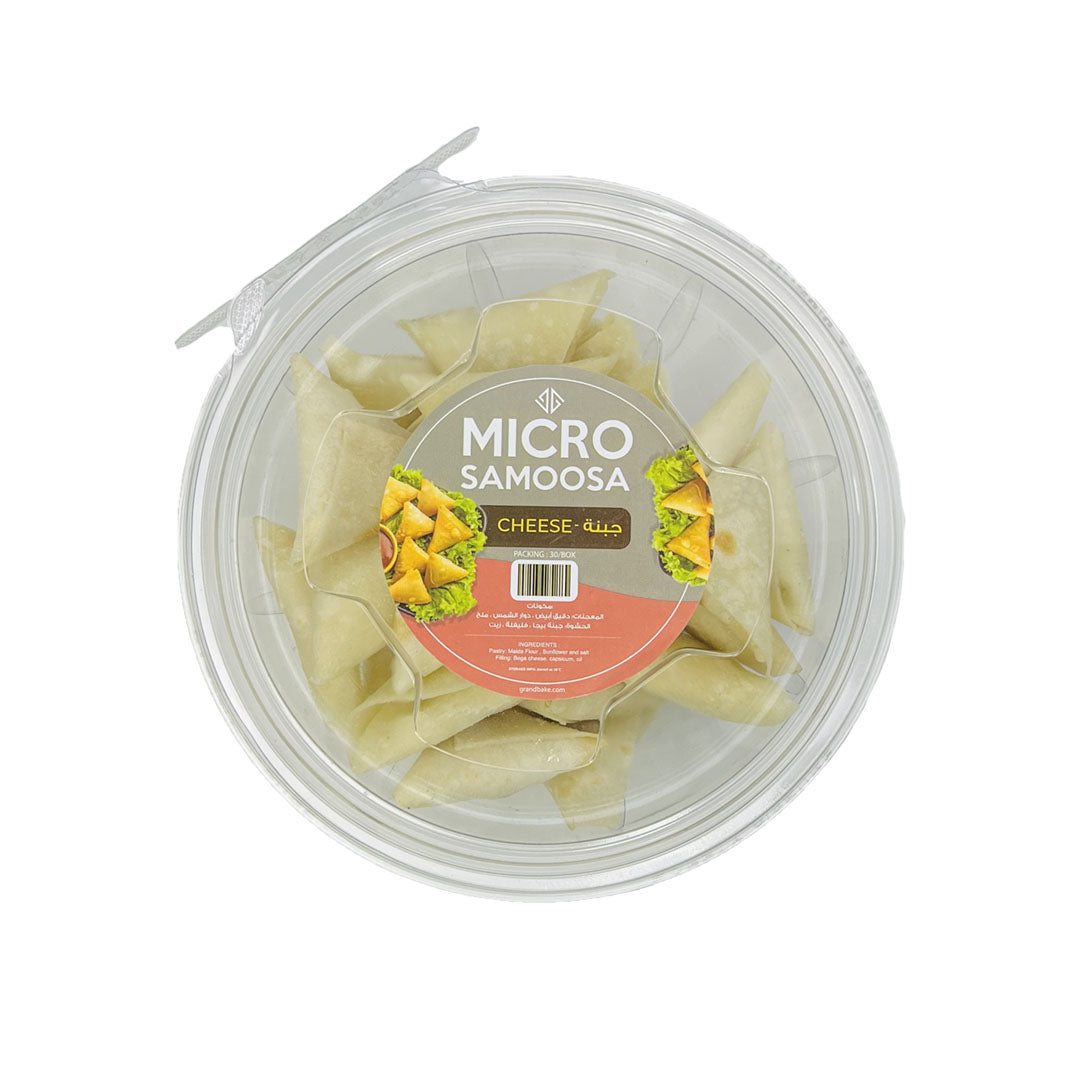 A clear plastic box containing 30 microsamosa cheese and vegetable fillings, sealed with a label displaying the product name and an image of the samosas.