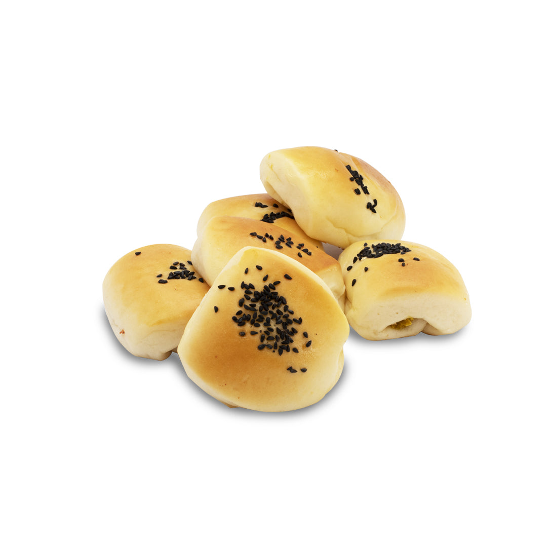 A group of ten frozen fatayer labneh pastries with visible  black sesame seeds on the top crust.