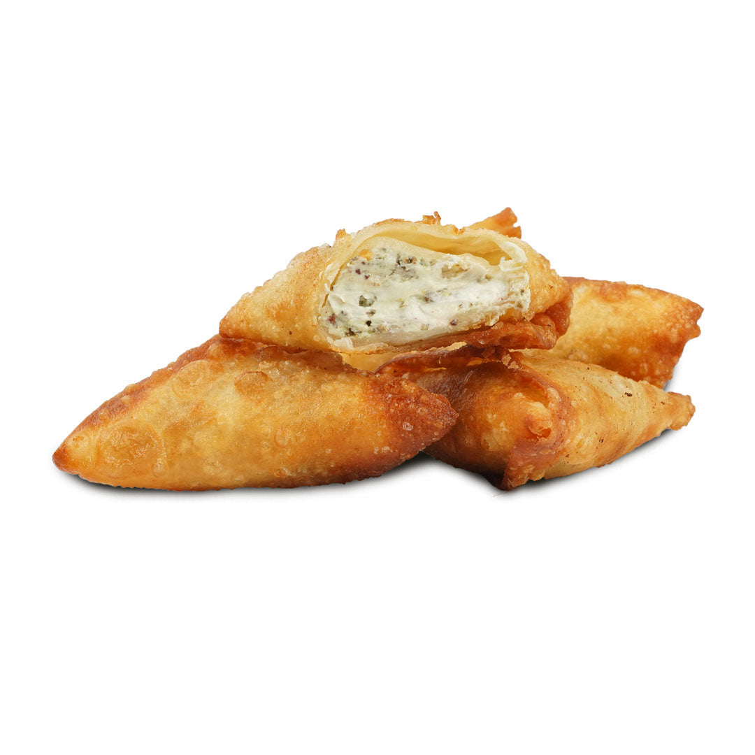 A photo showing three golden-brown samosas, with a visible filling of labneh (a type of Middle Eastern cream cheese) and zaatar spices.
